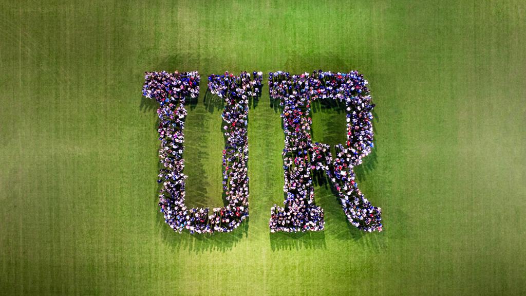 Photo of students forming the letters UR