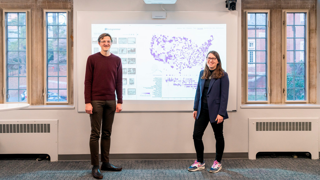 Taylor Arnold and Lauren Tilton in front of a map from the Photogrammar project