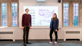Taylor Arnold and Lauren Tilton in front of a map from the Photogrammar project