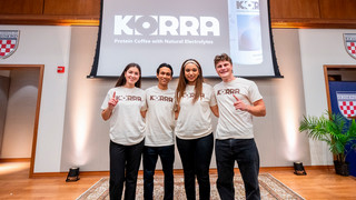 Four University of Richmond students pose in front of their winning product
