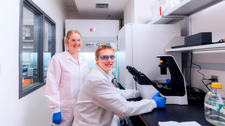 Julie Pollock in lab with student