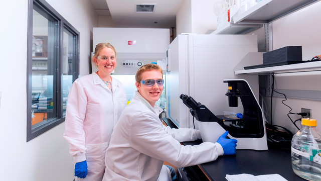 Julie Pollock in lab with student