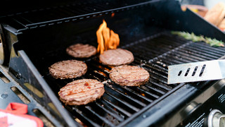 Burgers cooking on a grill