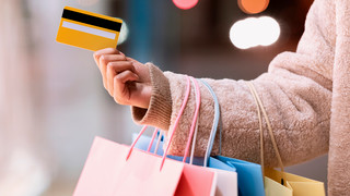 Woman with credit card and shopping bags