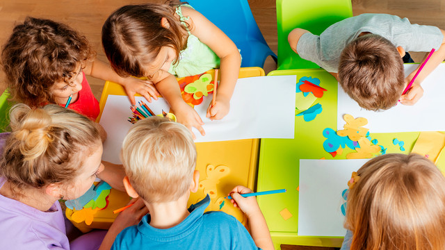 Children drawing at a table