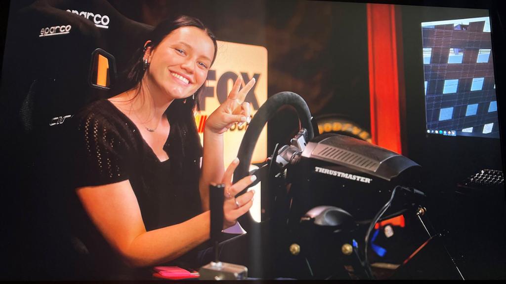 Regan Mccrossan in a race car simulator in the FOX Sports studio