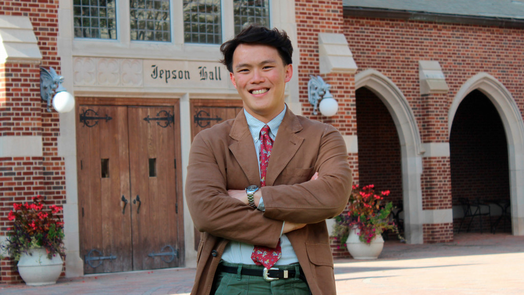 Senior Tim Khoh standing by the front doors of Jepson Hall