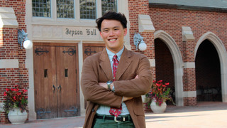 Senior Tim Khoh standing by the front doors of Jepson Hall