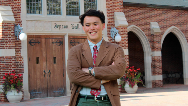 Senior Tim Khoh standing by the front doors of Jepson Hall