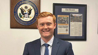 Senior Jack DeKorte standing by the U.S. House of Representatives seal