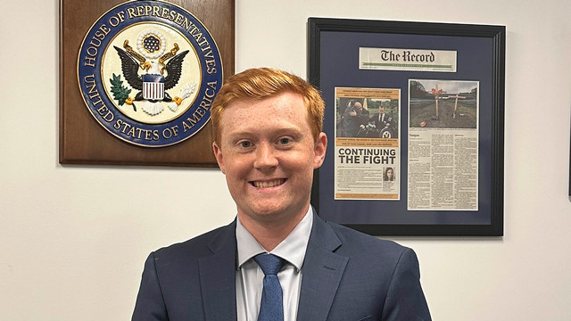 Senior Jack DeKorte standing by the U.S. House of Representatives seal