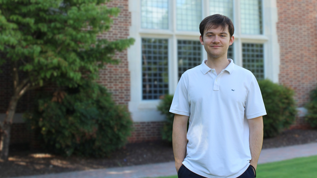 George Ruthven, '27, standing outside Jepson Hall