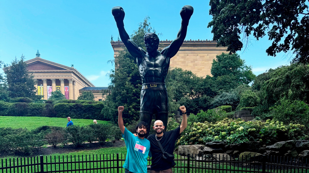 University of Richmond alums Marco Barcenas-Consuelo, '23, left, and Omar Ibrahim, '21, right, pose by the Rocky statue at the Philadelphia Museum of Art