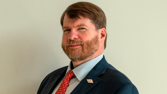 A headshot of Bruce Russell.