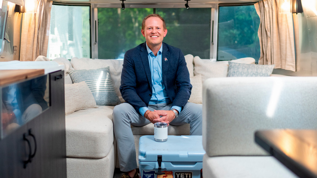 Dean of Richmond Law, Jacob Rooksby, sits in his Airstream trailer.