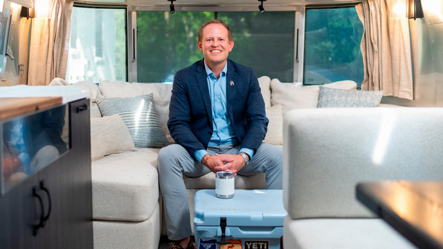 Dean of Richmond Law, Jacob Rooksby, sits in his Airstream trailer.