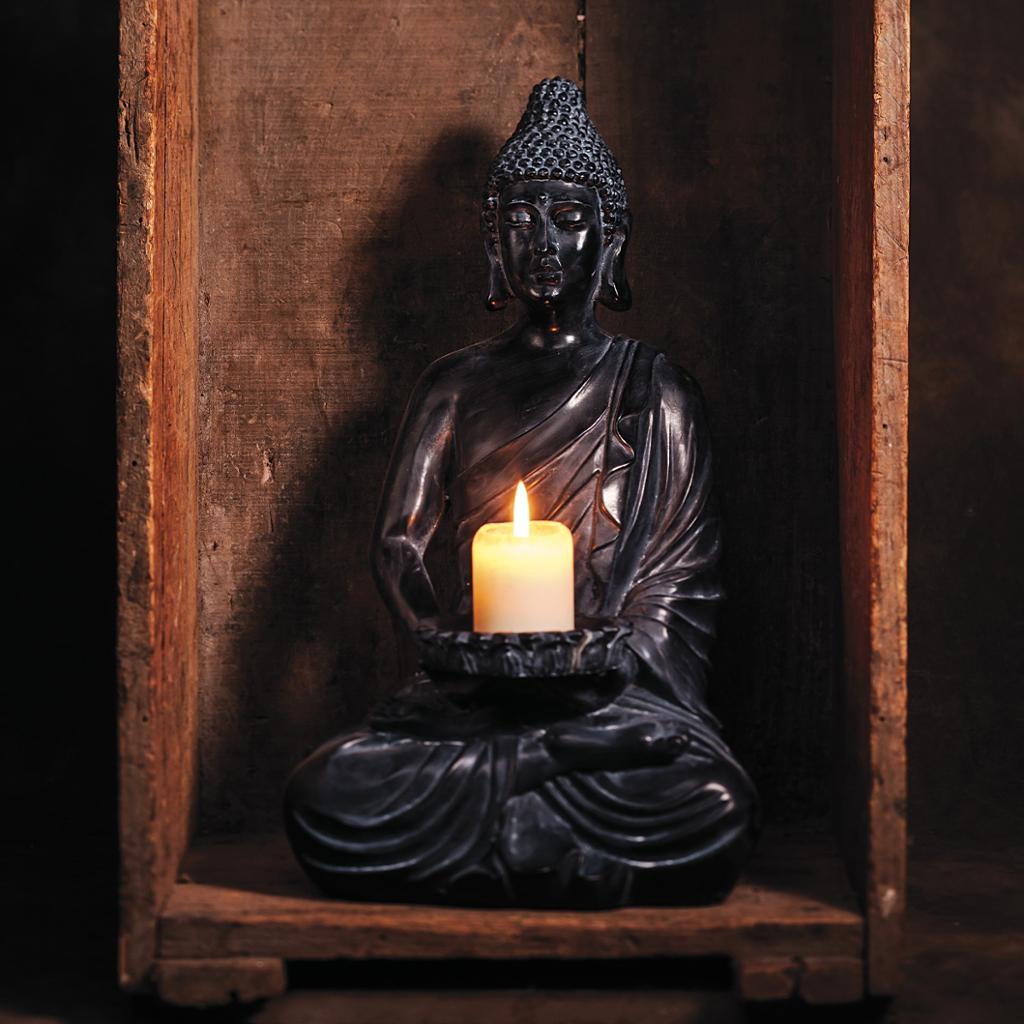A statue holding a lit candle 