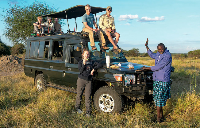 The Salley family sits on a tour jeep with their tour guide.