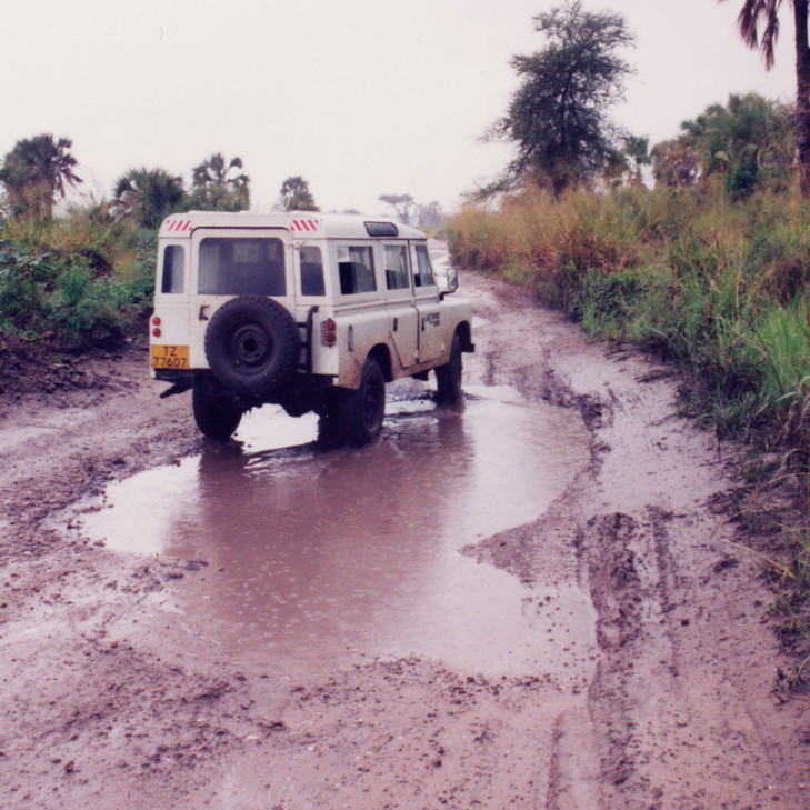 An old photo of a jeep stuck in the mud.