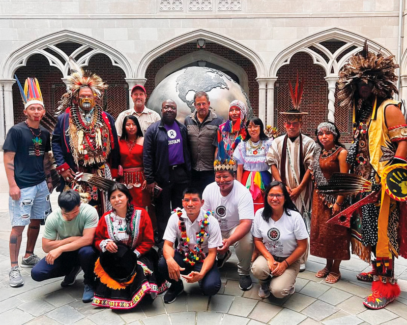 A photo of Indigenous leaders from the Amazon and Virginia on campus in the courtyard of the Carol Weinstein International Center.