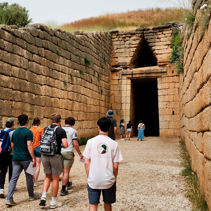 Group tours an ancient site in Mycenae, Greece