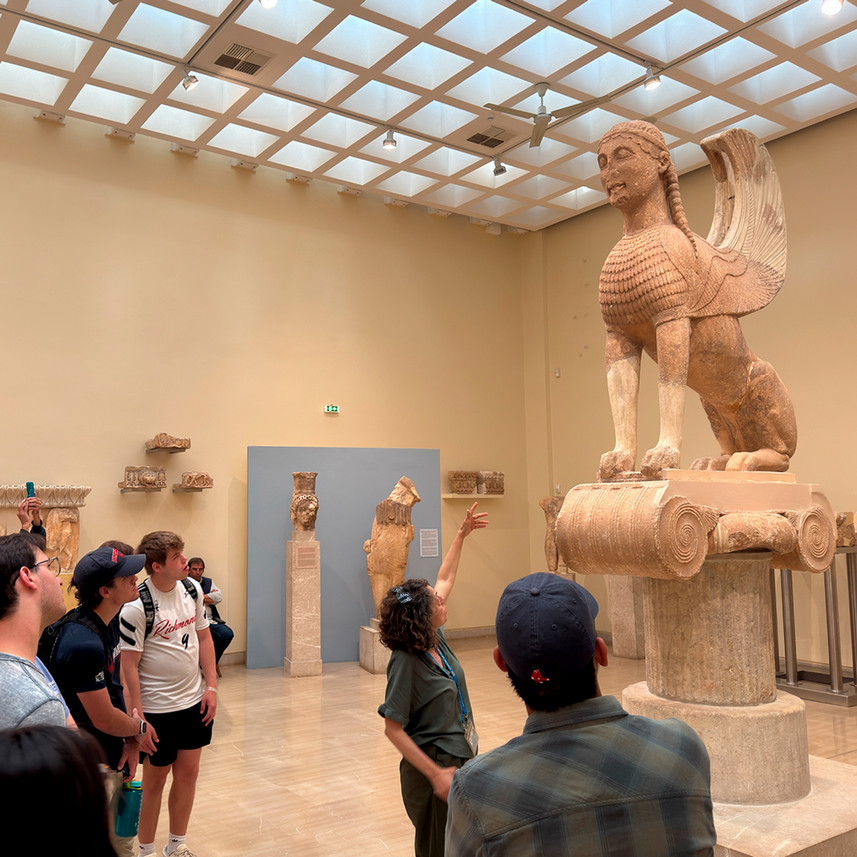 Tour guide describes a sculpture during a museum visit