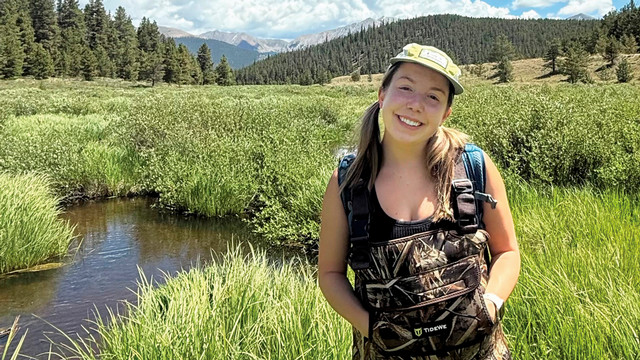 Rosalie Hinke, ’26, in an open field along a stream in Crested Butte, Colorado