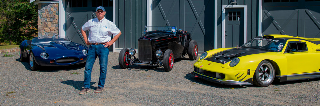 Dennis Kazmerowski, ’69, stands with three of his cars.
