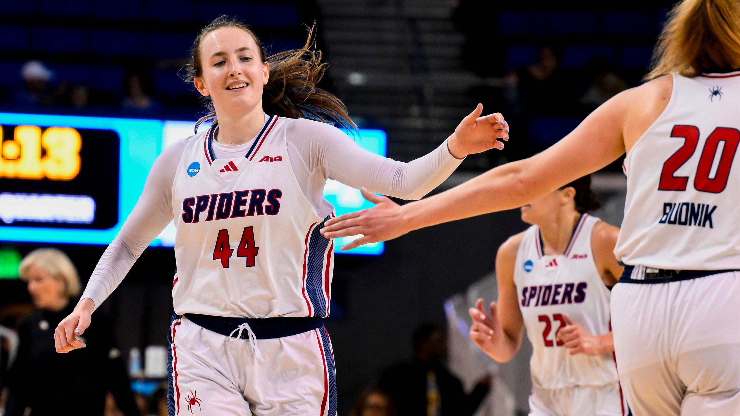 Maggie Doogan giving a teammate a high-five mid-game.