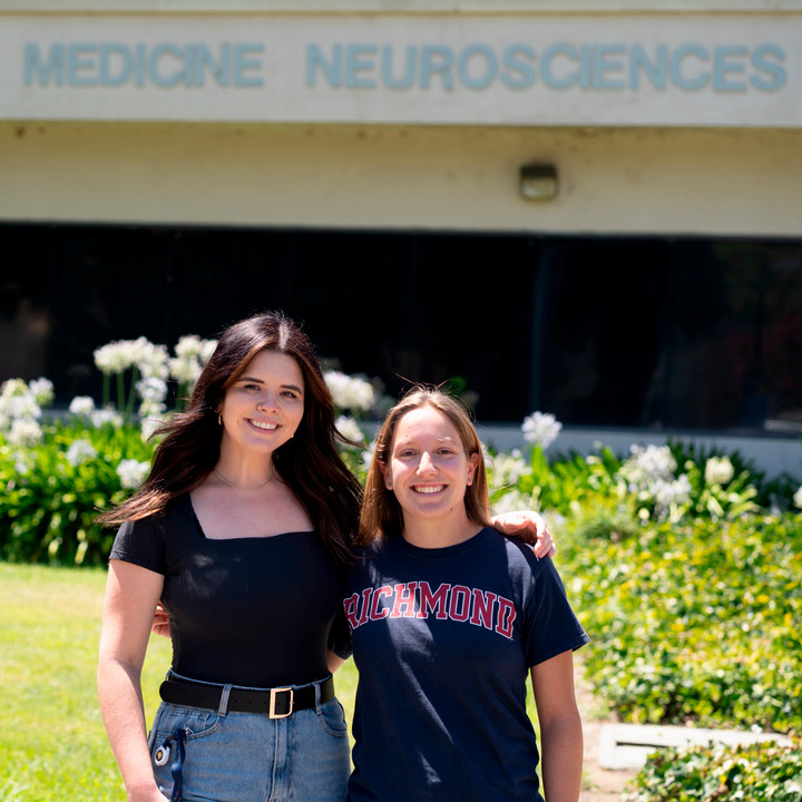 A photo of Kendall Stewart and Sarah Zoglin in front of the neuroscience building  at UC Davis.