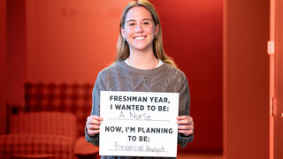 A student holding a sign saying 