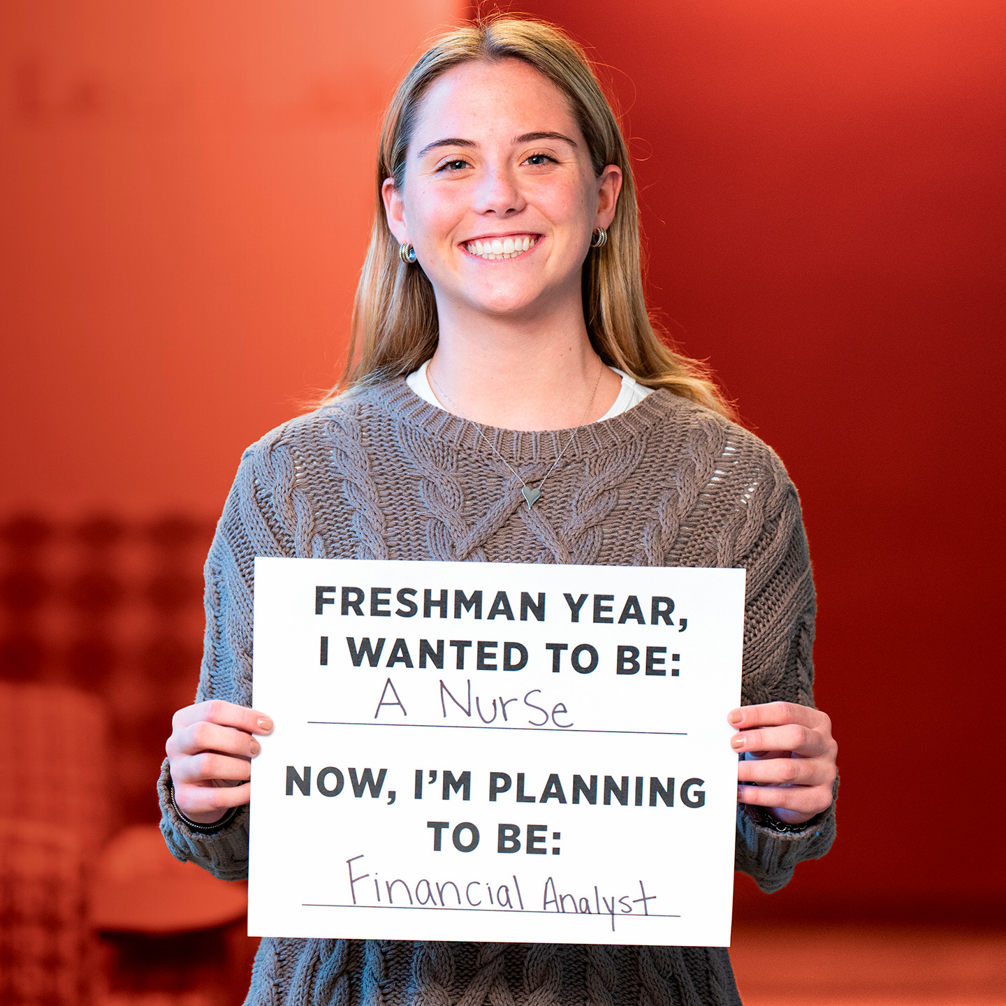 A student holding a sign saying 