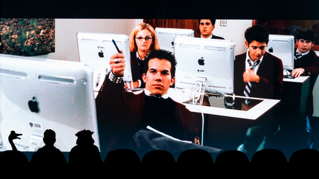 A scene from the movie cry wolf, where alumnae Shauna Havercamp Dugandzic, ’07 is visible. There are three silhouetted figures in the front, a la Mystery Science Theater 3000, but instead of a man and two aliens, its a man, triceragoose, and WebstUR.