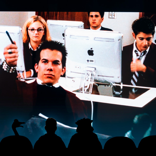 A scene from the movie cry wolf, where alumnae Shauna Havercamp Dugandzic, ’07 is visible. There are three silhouetted figures in the front, a la Mystery Science Theater 3000, but instead of a man and two aliens, its a man, triceragoose, and WebstUR.