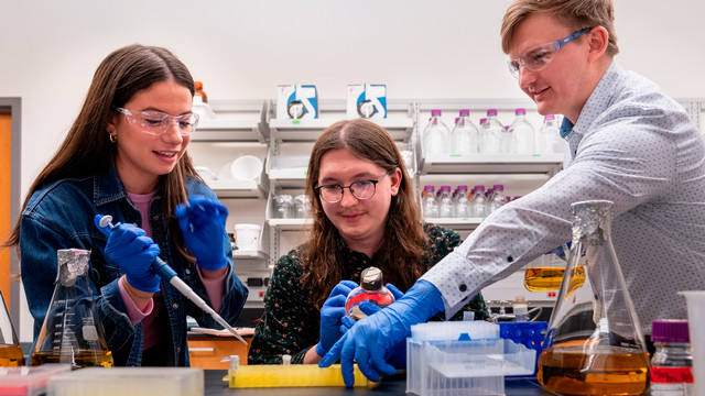 Students in biology lab with professor John Peters