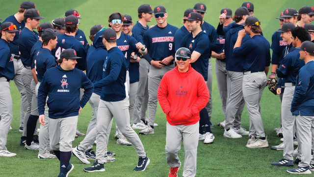 A photo of baseball coach Mik Aoki with the Spiders baseball team.
