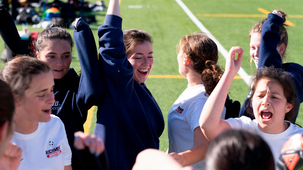 Club sports players cheer during a game.
