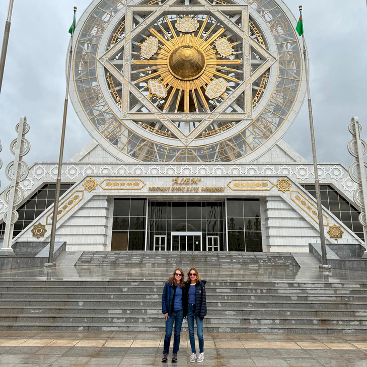 Katie Fishman stands in front of the World's Largest Indoor Ferris Wheel in Ashgabat, Turkmenistan.