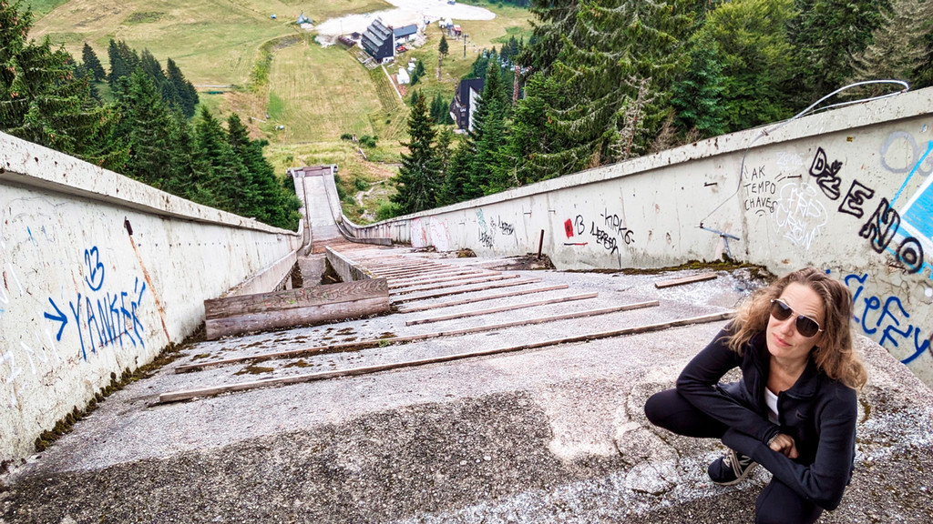 Katie Fishman stands at the top of an abandoned Ski jump in Bosnia.