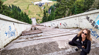 Katie Fishman stands at the top of an abandoned Ski jump in Bosnia.