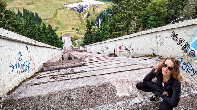 Katie Fishman stands at the top of an abandoned Ski jump in Bosnia.