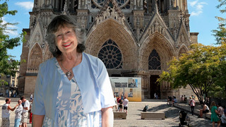 Rachel Pierce Newell, W'72, standing in front of Reims Cathedral in France.