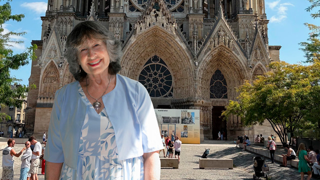 Rachel Pierce Newell, W'72, standing in front of Reims Cathedral in France.
