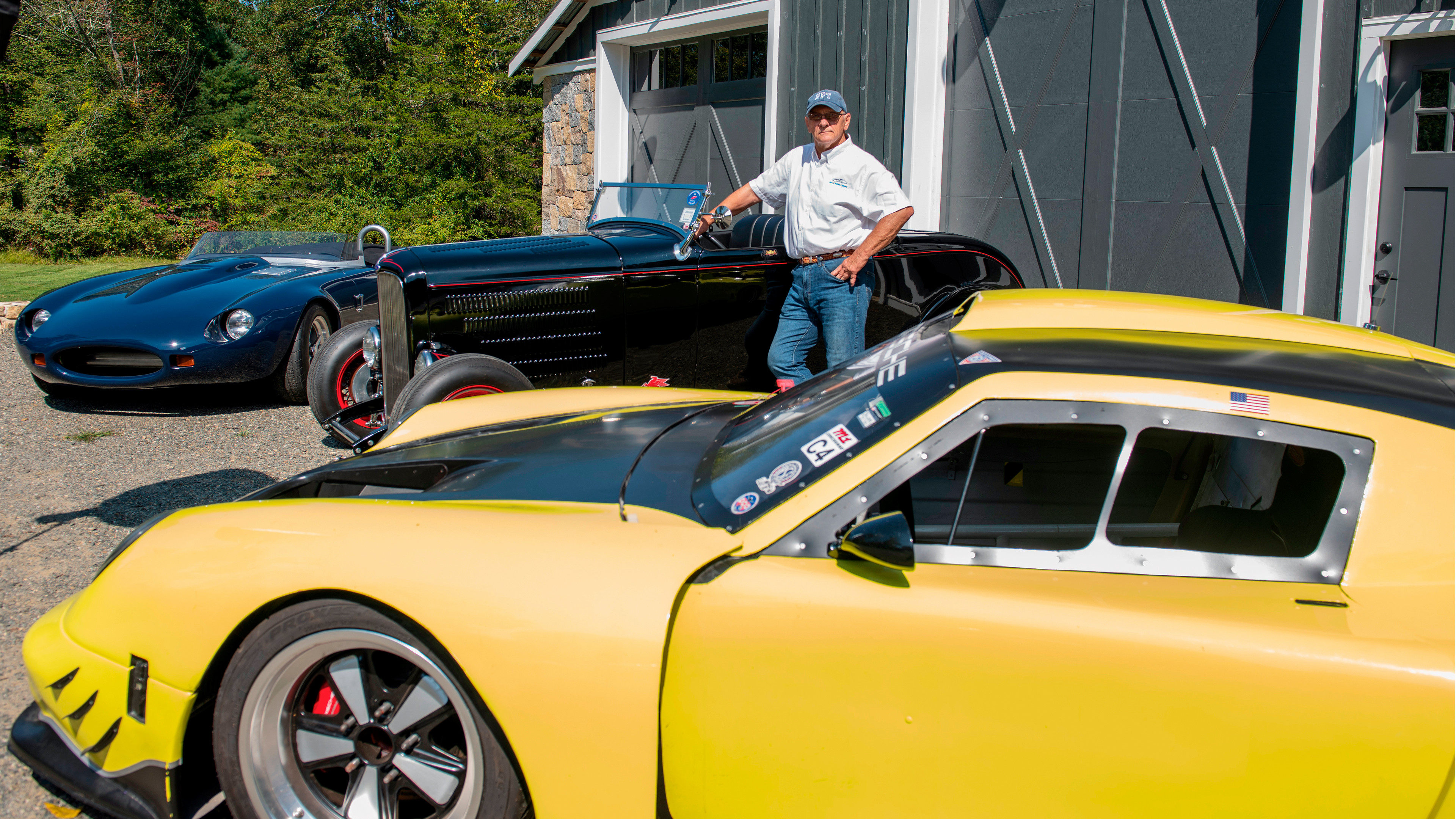 Dennis “Kaz” Kazmerowski stands with three of his cars.