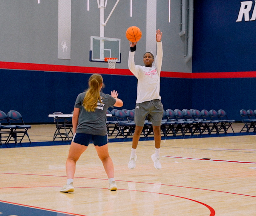 Alicia Newell shoots over Marisa Snee's head in a game of one on one basketball.