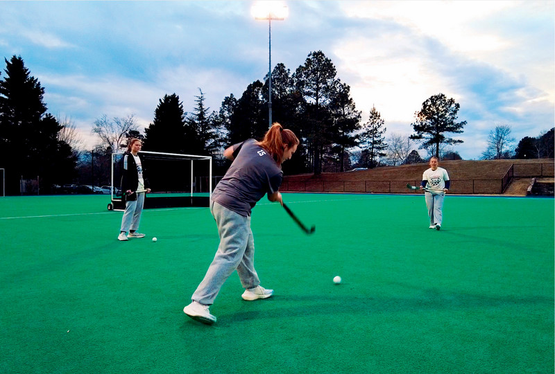 Marisa Snee passes the field hockey ball to Spider field hockey player Olivia Eusanio, as her teammate Caroline Simmons looks on.