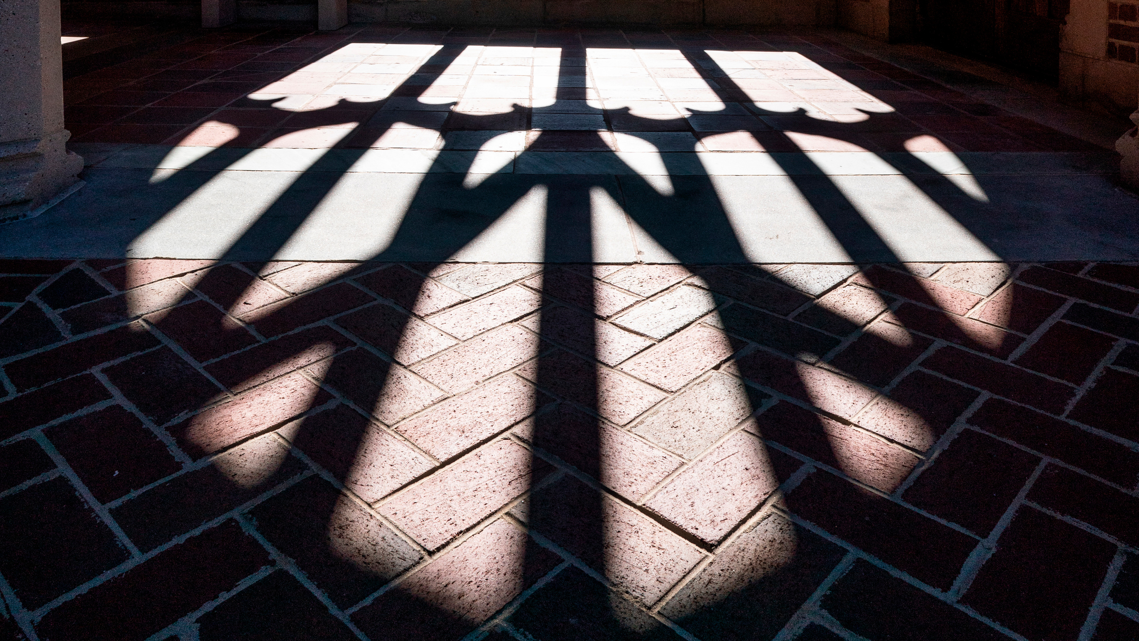 A shadow cast from the architecture of campus.