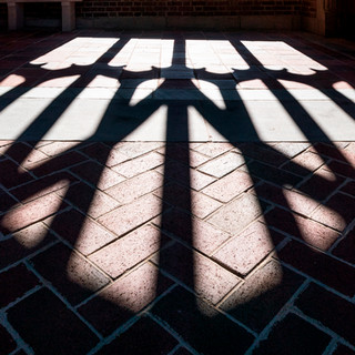 A shadow cast from the architecture of campus.