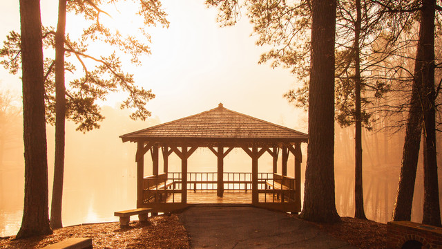Gazebo and Westhampton Lake in warm foggy sunrise