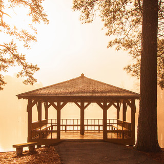 Gazebo and Westhampton Lake in warm foggy sunrise
